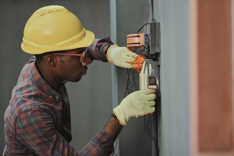 An electrical technician working on a service panel