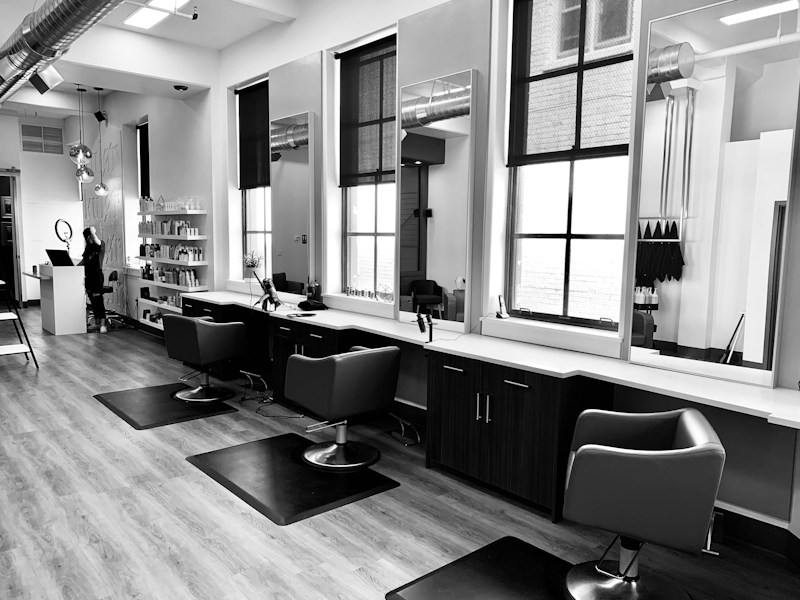 Warm salon interior with styling chairs and mirrors